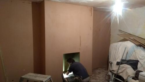 Plastered fireplace wall